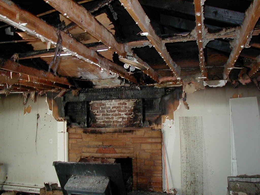 Structural fire damage being documented in detail for an insurance settlement